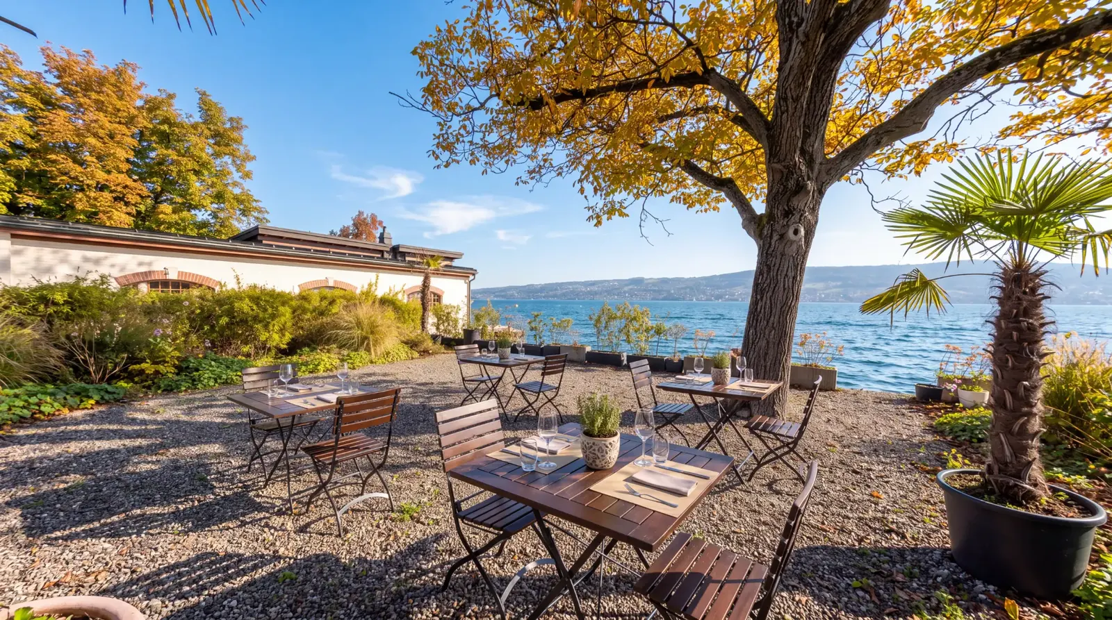 LAGO’s garden terrace directly on Lake Zurich, tables set under a tree in autumn